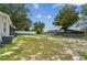 View of the backyard, showcasing the home's screened porch and lush greenery at 9259 Marler Rd, Spring Hill, FL 34608