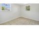 Bedroom with tile flooring, light walls, and dual windows, providing bright light at 9259 Marler Rd, Spring Hill, FL 34608
