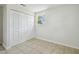 Bedroom with closet, neutral walls, tile flooring, and a window at 9259 Marler Rd, Spring Hill, FL 34608