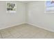 Bedroom with tile flooring, light walls, and dual windows, providing bright light at 9259 Marler Rd, Spring Hill, FL 34608