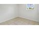 Bright bedroom features neutral walls, and tile flooring at 9259 Marler Rd, Spring Hill, FL 34608