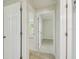 Hallway with tile flooring and multiple doors leading to various rooms at 9259 Marler Rd, Spring Hill, FL 34608