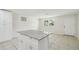 Kitchen island features grey granite countertop, white cabinets, and an open concept design at 9259 Marler Rd, Spring Hill, FL 34608