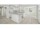 Bright kitchen with white cabinetry, stone countertops, stainless appliances, and a central island at 9259 Marler Rd, Spring Hill, FL 34608