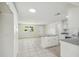 Open floor plan kitchen featuring white cabinets, and tile flooring at 9259 Marler Rd, Spring Hill, FL 34608