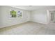 Bright living room featuring tile flooring and neutral walls, leading to another room at 9259 Marler Rd, Spring Hill, FL 34608