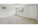 Bright living room featuring tile flooring, neutral walls, and a large window at 9259 Marler Rd, Spring Hill, FL 34608