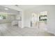 Open floor plan living room with sliding glass doors and kitchen at 9259 Marler Rd, Spring Hill, FL 34608