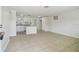 Spacious living room with tile flooring and neutral paint, flowing seamlessly into the updated kitchen at 9259 Marler Rd, Spring Hill, FL 34608