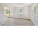 Bright living room with tile floors, large window and sliding glass door at 9259 Marler Rd, Spring Hill, FL 34608