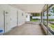 View of the screened in patio with white walls and door, a perfect spot for relaxation at 9259 Marler Rd, Spring Hill, FL 34608