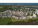 Aerial view of the community with lush landscaping, surrounded by trees and a nearby lake at 10033 64Th N Ave # 4, St Petersburg, FL 33708