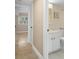 View from bathroom to bedroom with safety bars in shower and marble vanity at 10033 64Th N Ave # 4, St Petersburg, FL 33708