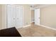 Neutral bedroom with Travertine floors, bi-fold doors, and an open doorway at 10033 64Th N Ave # 4, St Petersburg, FL 33708