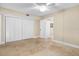 Bedroom with travertine tile floors, ceiling fan, and large closet space at 10033 64Th N Ave # 4, St Petersburg, FL 33708