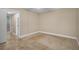 Neutral bedroom boasts tiled floors and a doorway that leads to a private bathroom at 10033 64Th N Ave # 4, St Petersburg, FL 33708