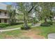Beautiful courtyard with mature trees, manicured landscaping and walking paths in a tranquil setting at 10033 64Th N Ave # 4, St Petersburg, FL 33708