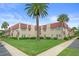 Inviting exterior view of the condominium building showcasing lush landscaping and well-maintained grounds at 10033 64Th N Ave # 4, St Petersburg, FL 33708