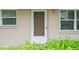 Close-up of the front door, painted brown, featuring a white doorframe and house number at 10033 64Th N Ave # 4, St Petersburg, FL 33708