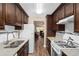 Well-lit kitchen featuring dark wood cabinets, granite countertops, and stainless steel appliances at 10033 64Th N Ave # 4, St Petersburg, FL 33708