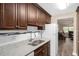 Bright kitchen featuring granite countertops, stainless steel sink, and dark wood cabinetry at 10033 64Th N Ave # 4, St Petersburg, FL 33708