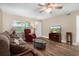 Cozy living room with a ceiling fan, hardwood floors, and comfortable furniture at 10033 64Th N Ave # 4, St Petersburg, FL 33708