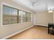 Bright living room with expansive windows, wood-look floors, and neutral tones at 10033 64Th N Ave # 4, St Petersburg, FL 33708