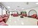 A spacious lounge with red leather seating and a decorative white brick wall at 10033 64Th N Ave # 4, St Petersburg, FL 33708