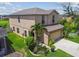 Two story home with a well manicured lawn, beautiful landscaping, and an attached two car garage at 1012 Seminole Sky Dr, Ruskin, FL 33570