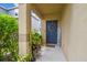 Inviting front entrance featuring a blue door, welcome sign, and lush landscaping at 1012 Seminole Sky Dr, Ruskin, FL 33570