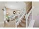 Bright living room with staircase, neutral walls, and cozy furniture at 1012 Seminole Sky Dr, Ruskin, FL 33570