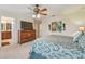 This main bedroom features a ceiling fan, and an ensuite bathroom visible through an open door at 1012 Seminole Sky Dr, Ruskin, FL 33570