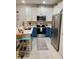 Well-equipped kitchen with stainless steel appliances and stylish blue and white cabinets at 10824 Quickwater Ct, Riverview, FL 33569