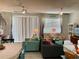 Bright living room with two ceiling fans and sliding glass doors to patio at 10824 Quickwater Ct, Riverview, FL 33569