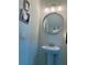 Charming powder room with pedestal sink, decorative mirror, and neutral paint at 10824 Quickwater Ct, Riverview, FL 33569