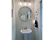 Charming powder room with pedestal sink, decorative mirror, and neutral paint at 10824 Quickwater Ct, Riverview, FL 33569