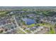 Scenic aerial view of a well-maintained neighborhood adjacent to a serene lake and green spaces at 11913 Butler Woods Cir, Riverview, FL 33579