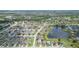 Aerial view of a home situated in a suburban neighborhood with nearby ponds and green spaces at 11913 Butler Woods Cir, Riverview, FL 33579