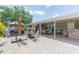 This backyard features an outdoor kitchen and seating area with a covered patio and a brick-paved patio at 11913 Butler Woods Cir, Riverview, FL 33579