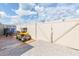 This backyard features a well-maintained lawnmower, a trailer, and a white fence at 11913 Butler Woods Cir, Riverview, FL 33579