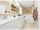 Bathroom featuring dual sinks, decorative mirrors, and shower-tub combo at 11913 Butler Woods Cir, Riverview, FL 33579