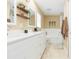 Bathroom with double vanity, decorative mirror, and shower-tub combo at 11913 Butler Woods Cir, Riverview, FL 33579