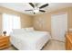Inviting bedroom featuring a comfortable bed, ceiling fan, and ample closet space at 11913 Butler Woods Cir, Riverview, FL 33579