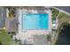 Overhead shot of community pool with a geometric design, enhanced by a lush landscape at 11913 Butler Woods Cir, Riverview, FL 33579