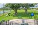 Outdoor dog park with lush turf, agility equipment, picnic tables, and shade trees at 11913 Butler Woods Cir, Riverview, FL 33579