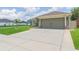 Charming home featuring a two-car garage, lush lawn, and well-maintained driveway at 11913 Butler Woods Cir, Riverview, FL 33579