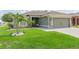 Well-manicured lawn complements this charming home, complete with a two-car garage and inviting front entryway at 11913 Butler Woods Cir, Riverview, FL 33579