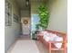 Inviting front porch featuring a cozy bench, potted plants, and a welcoming wreath on the front door at 11913 Butler Woods Cir, Riverview, FL 33579