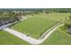 Scenic aerial view of a golf course featuring a driving range with manicured lawns and a practice area at 11913 Butler Woods Cir, Riverview, FL 33579