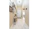 Hallway featuring neutral walls, tile floors, and an artfully decorated wall at 11913 Butler Woods Cir, Riverview, FL 33579